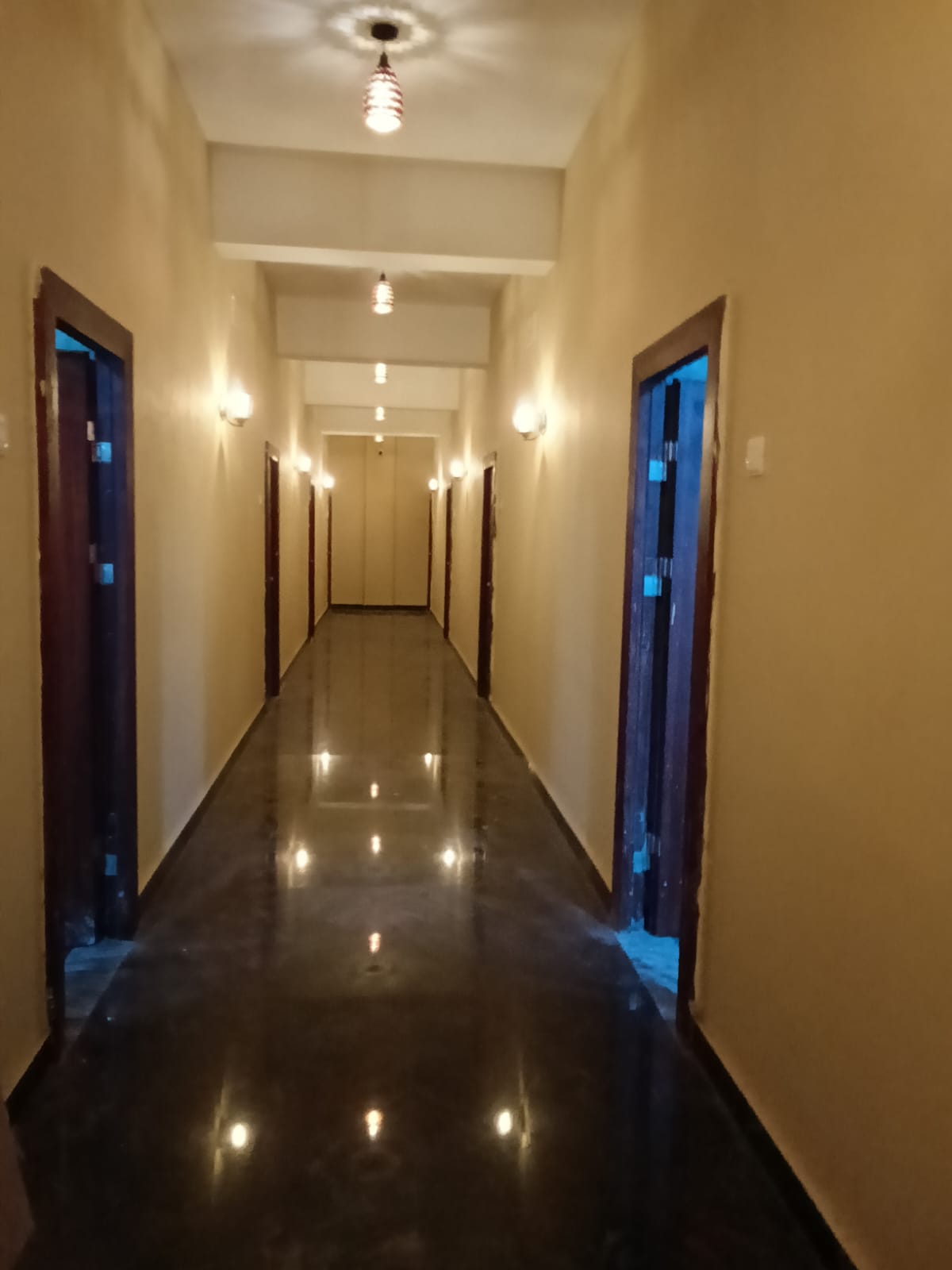 Lit residency corridor leading to guest rooms