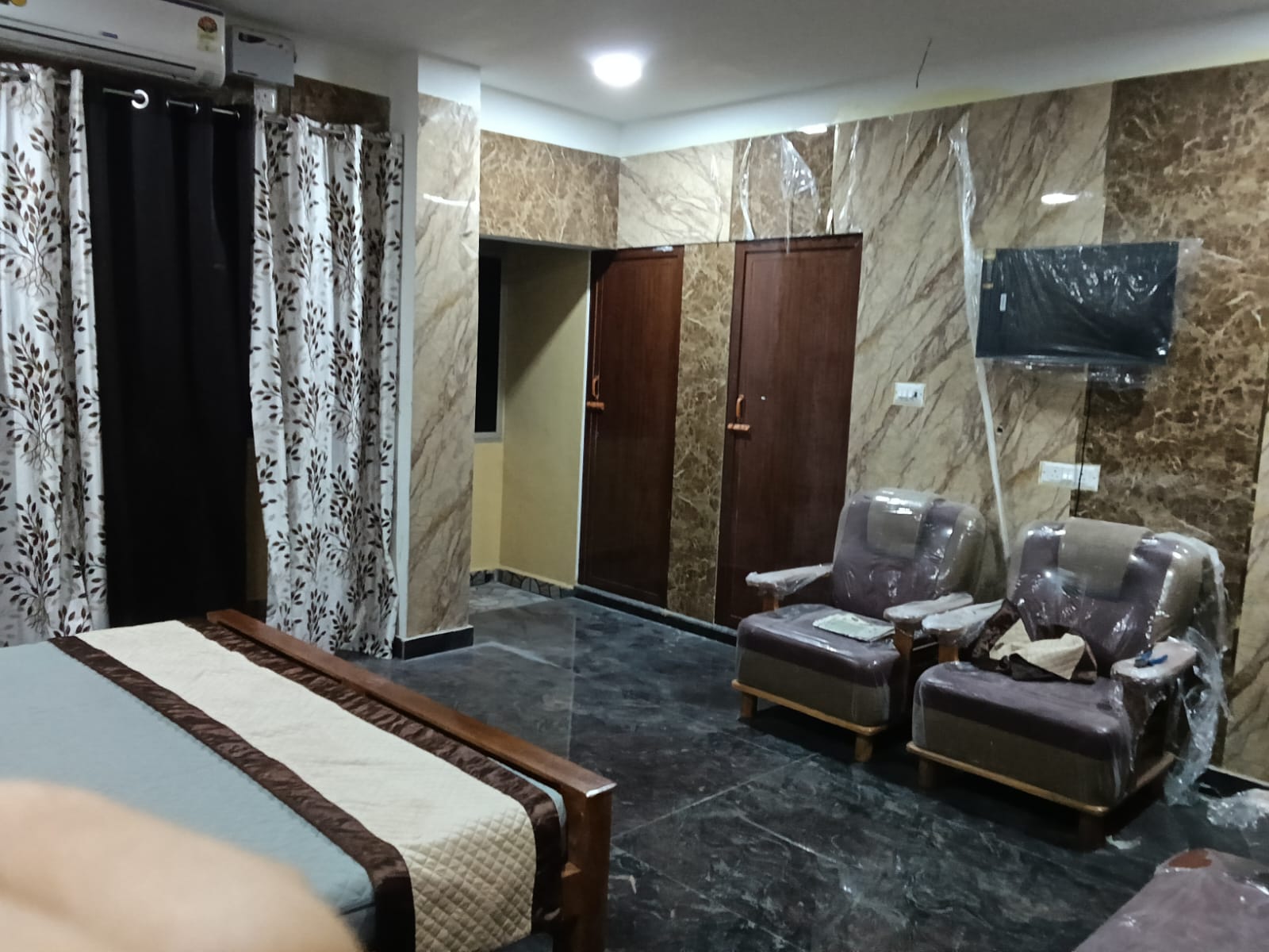 Spacious family room with sofa seating, wardrobes and wall-mounted Smart TV